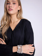 Blusa ascollo a V e maniche a sbuffo