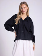 Blusa ascollo a V e maniche a sbuffo