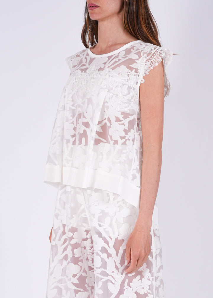 Top in pizzo ricamato con trasparenze floreali