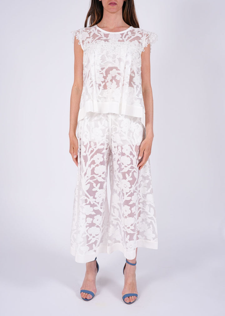 Top in pizzo ricamato con trasparenze floreali